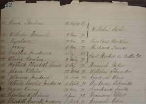 Photo of a portion of page 22 in Marine UCC record book showing the baptisms of Lillie and her younger sister (#146 and #147). Their mother's name was recorded as Caroline Muelhberg.